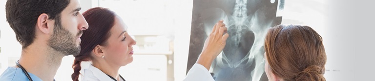 group of doctors looking at a patients xray