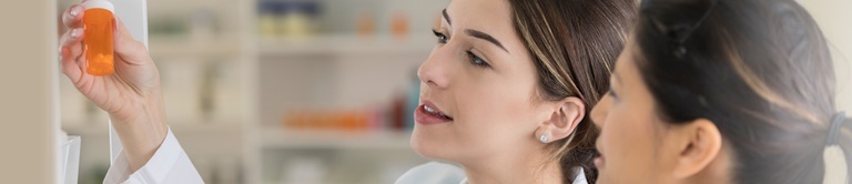 two pharmacists looking at a pill bottle