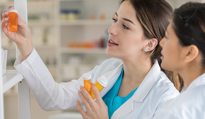 looking at a pill bottle in a pharmacy
