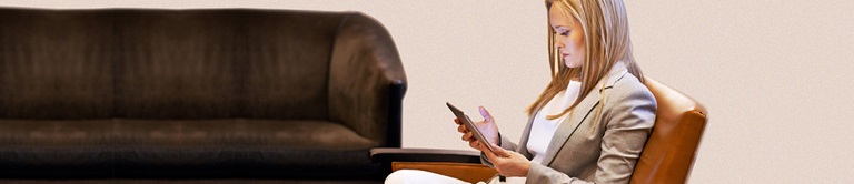 woman using an ipad in a chair