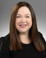 Headshot of Angela Joneson wearing black with long dark hair