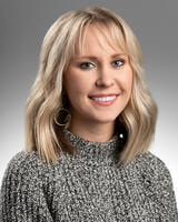 Headshot of Katie Moen in grey shirt 