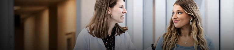 Woman talking with doctor in the hallway