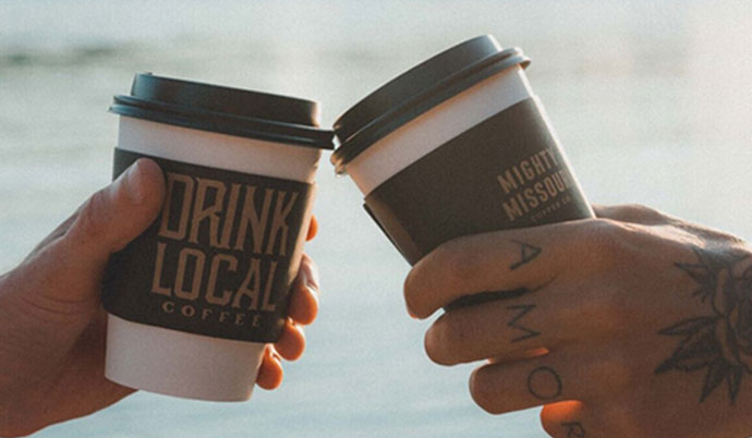 2 hands holding coffee cups.