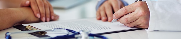 signing a document on a clipboard