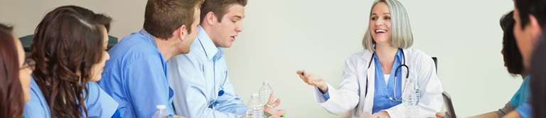 group of doctors talking around a table