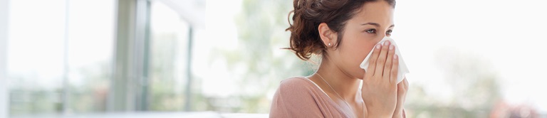 woman blowing her nose