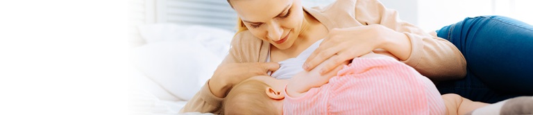 woman breastfeeding at home