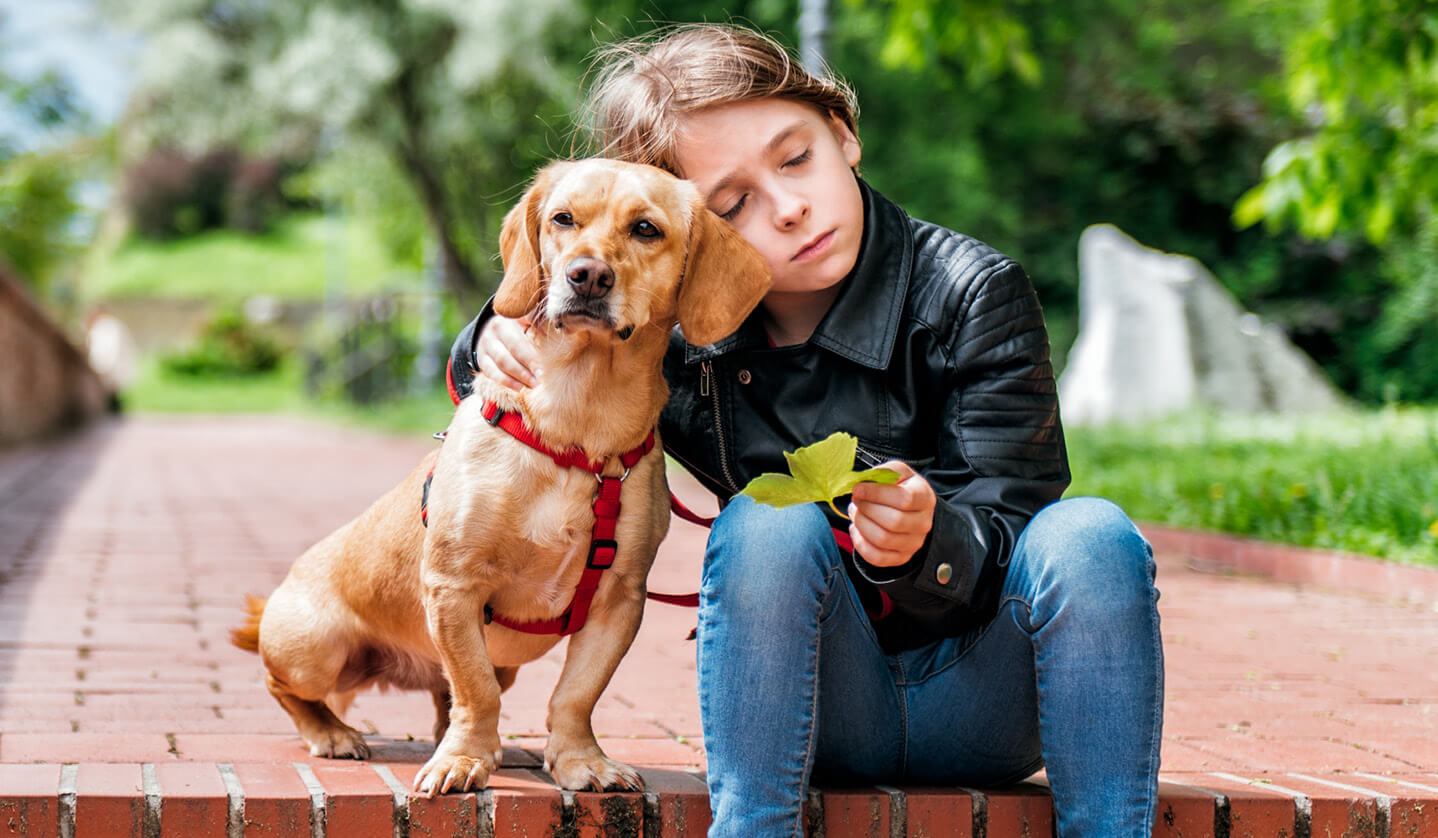 sad boy sitting with his dog