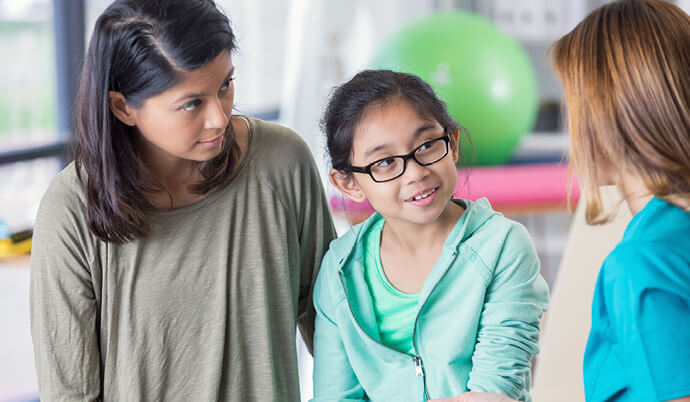 mom and daughter talking with a specialist