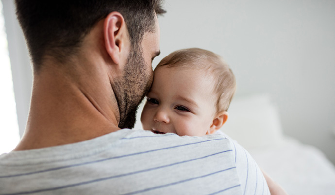 dad holding baby in his arms