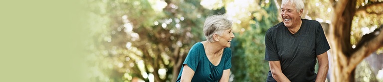 older couple smiling together outside