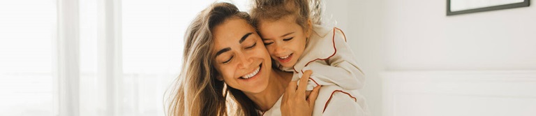 A mom and child hugging.