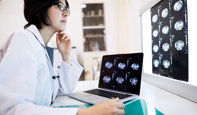 doctor looking at scans on a computer