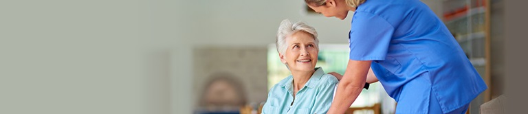 nurse helping a resident in a nursing home