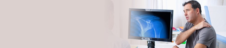 Doctor examining shoulder x-ray with patient