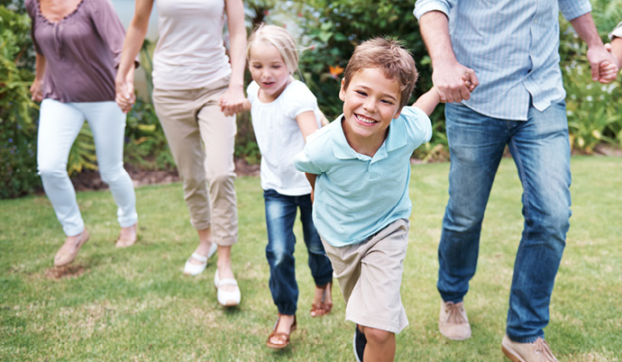 little boy holding hand with family running