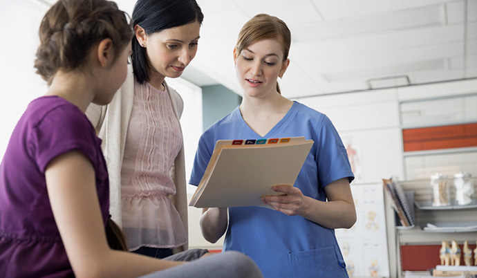 nurse talking to mom and daughter