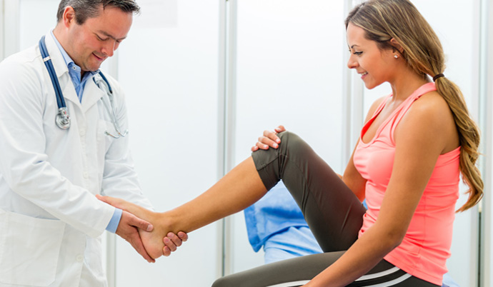 doctor examining a young girls ankle