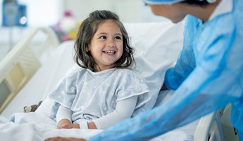 Smiling child with surgeon