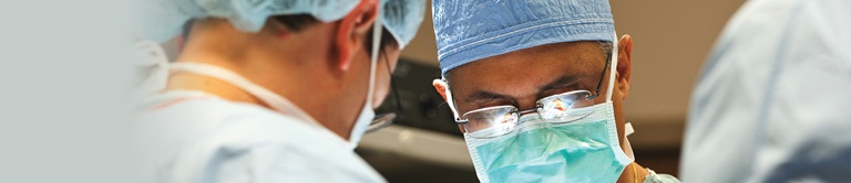 surgeons looking down at operating table