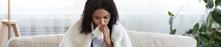 woman blowing her nose