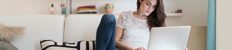 woman working on a laptop on a couch