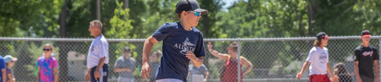 Kid running to next base in baseball