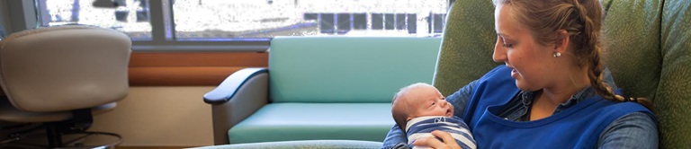 young woman holding newborn baby